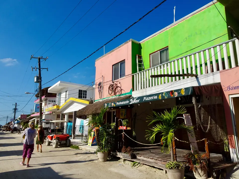 Calle con tiendas y restaurantes de colores en el centro de Holbox